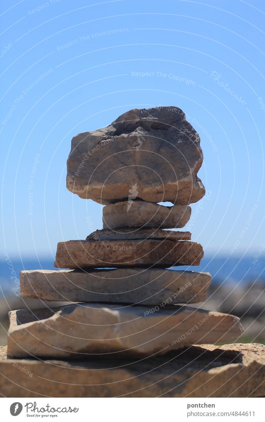 Gestapelte Steine am Meer Stapelsteine meer hype schwer kinderspiel Außenaufnahme Sommer himmel Menschenleer