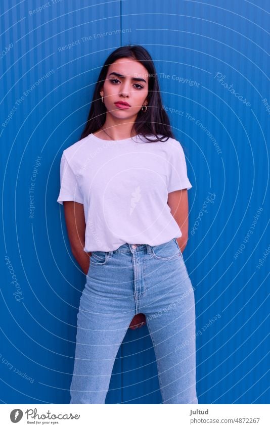 Porträt einer jungen arabischen Frau vor einer blauen Wand Mädchen Ethnizität Spanien Zwanziger Jahre trendy Gebäudeaußenseite junge Frau junge Erwachsene