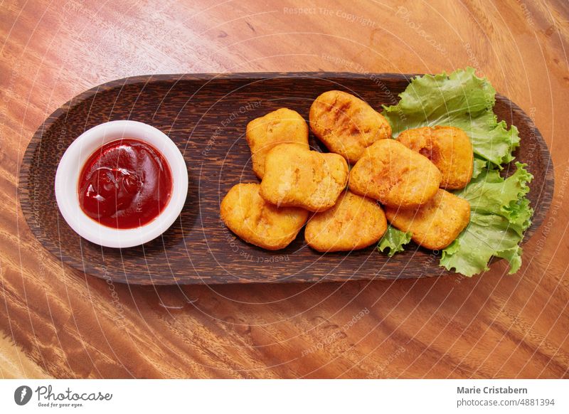 Blick von oben auf einen Teller mit hausgemachten Chicken Nuggets als Snacks hausgemachte Snacks Ansicht von oben Draufsicht Fingerfood Feinschmecker