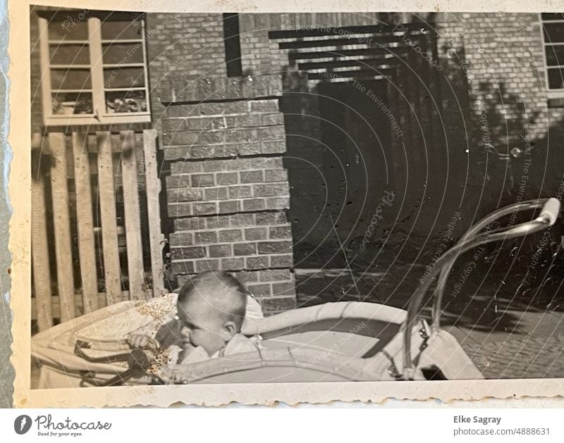 Altes ,analoges Foto 1949 Kind im Kinderwagen altes altes Foto Schwarzweißfoto Vergangenheit Außenaufnahme Erinnerung früher bewahren Kindheit