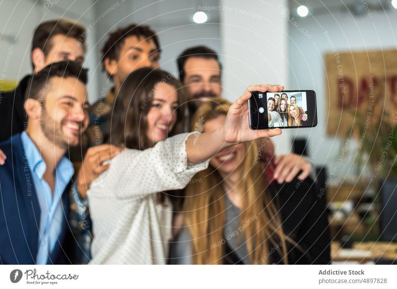 Fröhliche Kollegen machen ein Selfie im Büro Geschäftsleute Selbstportrait Bonden Business Smartphone Menschengruppe Unternehmen Arbeit Mitarbeiterin positiv