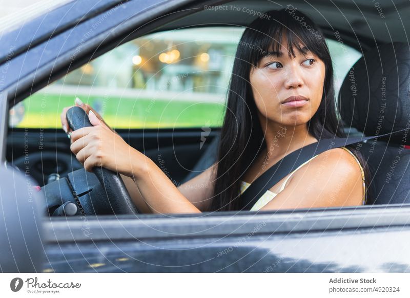 Lächelnde Frau, die Auto fährt und das Armaturenbrett benutzt - ein  lizenzfreies Stock Foto von Photocase
