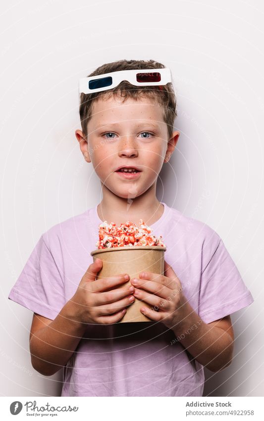 Junge mit 3D-Brille und Popcorn Kind 3d Popkorn Snack Glück Freude Vergnügen Film Leckerbissen wow Licht Eimer starren verblüfft froh Hobby Kino Lebensmittel