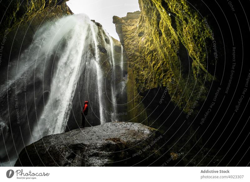 Anonymer Reisender genießt die Energie eines mächtigen Wasserfalls in einer felsigen Schlucht Person Natur Tourist bewundern genießen malerisch Landschaft