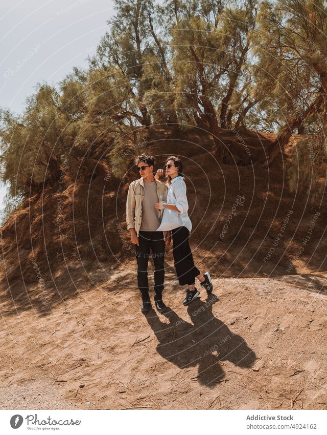 Junges reisendes Paar bewundert die Natur im Urlaub in der Wüste wüst bewundern Zusammensein kuscheln Stil Hügel Liebe Partnerschaft Sand Ausflug Abenteuer