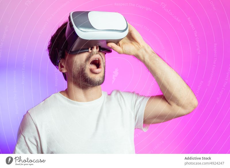 Staunender Mann mit VR-Brille Virtuelle Realität Cyberspace futuristisch modern eintauchen Erfahrung erstaunt simulieren Schutzbrille Erstaunen Mund geöffnet