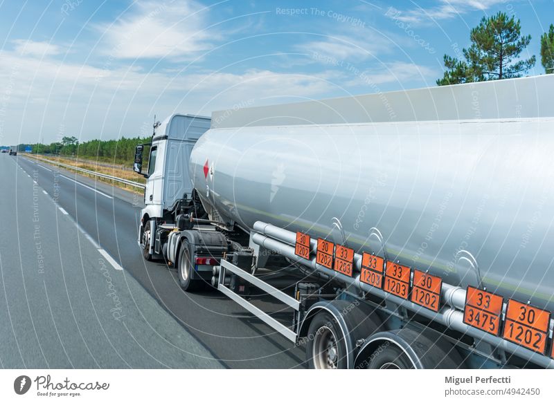 Tankwagen, der auf der Autobahn verkehrt, mit orangefarbenen Tafeln, die die Gefahr und die transportierte Ware kennzeichnen, Transport nach ADR-Vorschriften.