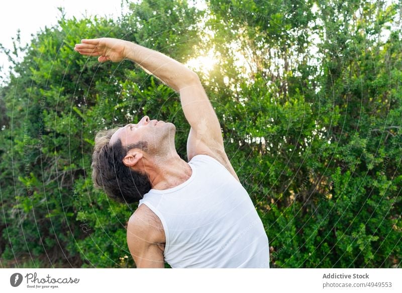 Männlich in umgekehrter Krieger-Pose im Sommer Mann Yoga Sitzung Park Gleichgewicht umgekehrte Krieger-Pose Arm angehoben Backend Dehnung männlich Windstille