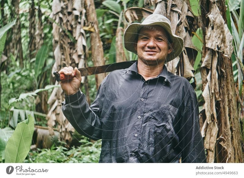 Hispanischer Bauer mit Machete im Dschungel Mann Landwirt Banane Ökologie Lächeln Arbeit Ackerbau Porträt Costa Rica männlich Klinge Messer hispanisch ethnisch