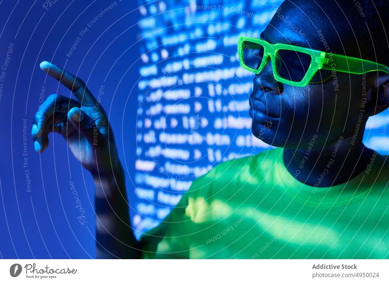 Junges Schwarzes mit trendiger Sonnenbrille Mann cool Stil Projektor digital selbstbewusst manifestieren tausendjährig männlich jung Afroamerikaner schwarz