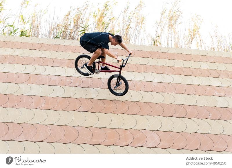 Junger Mann fährt mit BMX-Rad einen Abhang hinunter Mitfahrgelegenheit bmx Galle Berghang Skateplatz Trick Wallride Wochenende Hobby männlich Sommer Aktivität