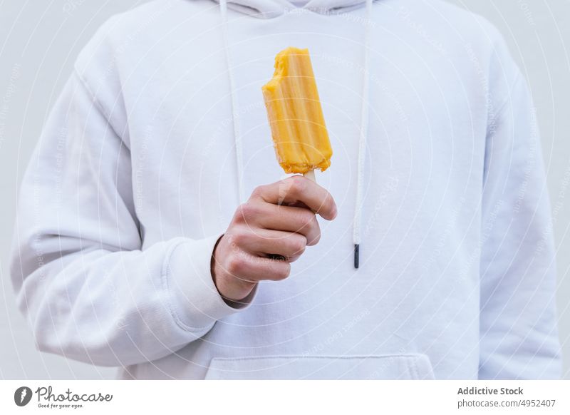 Anonymer Mann mit Natureislutscher schaut in die Kamera Eis Kies Speiseeis kalt natürlich gefroren Leckerbissen süß männlich aktualisieren geschmackvoll Dessert