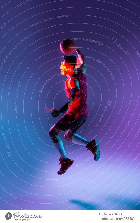 Studio Shot von Basketball-Spieler im Studio mit lila Hintergrund Aktion Werbung Kunst Athlet Ball Unschärfe farbenfroh Konkurrenz Konzept Zeitgenosse kreativ