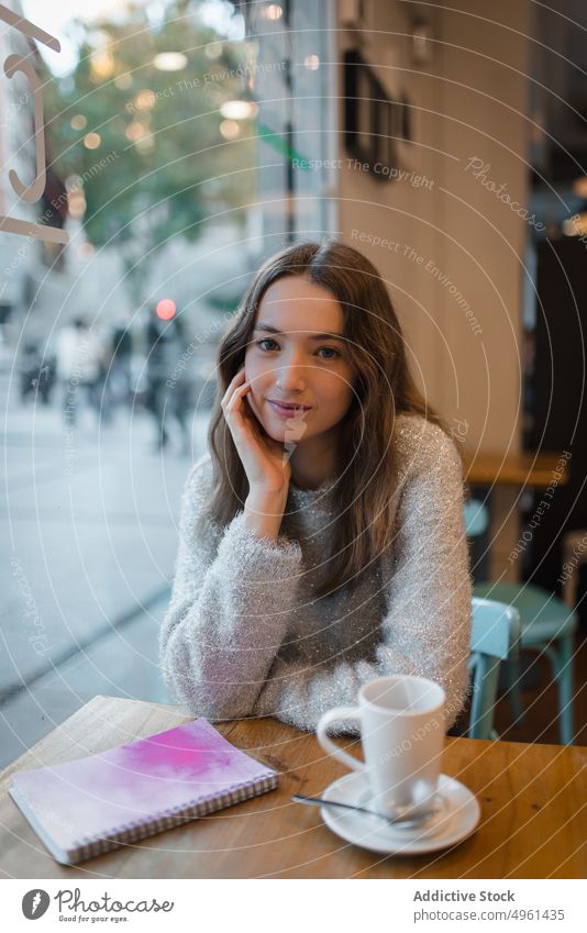 Ruhige Frau beim Chillen im Café am Wochenende Kälte Kaffee Tasse ruhig verträumt nachdenklich sich[Akk] entspannen Tisch Getränk trinken ruhen Heißgetränk jung