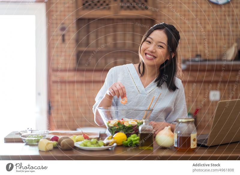 Asiatische Frau gibt Shrimps in den Salat Granele hinzufügen Salatbeilage Schalen & Schüsseln Koch Rezept Mittagessen Küche heimwärts jung asiatisch ethnisch
