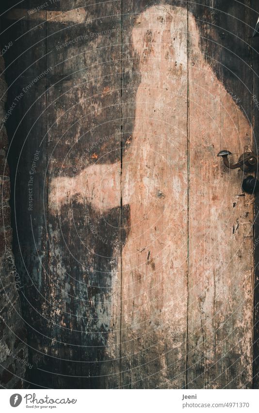 Geheimnisvolle Figur auf der alten Holztür geheimnisvoll mystisch Mythologie Schatten Tür geschlossen Eingangstür Griff historisch unheimlich Vergangenheit
