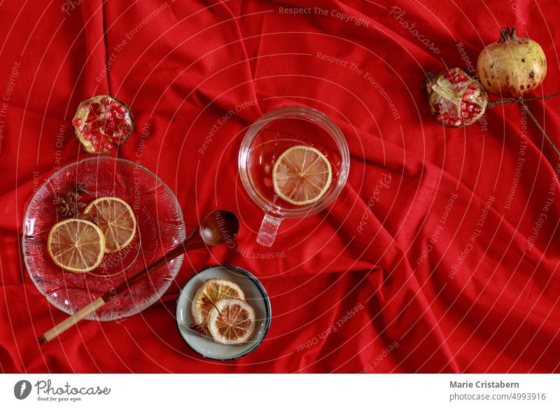 Draufsicht auf Granatapfelfrüchte und Zitronenscheiben auf rotem Hintergrund, um frischen Saft herzustellen, der Wellness und Herbstästhetik zeigt Design Saison