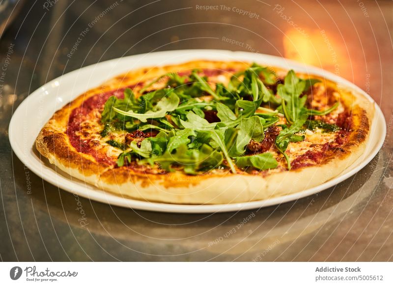 Leckere Pizza mit Rucola-Blättern Teller Mittagessen dienen Blatt Kraut Tisch Pizzeria Tradition italienische Küche Speise Lebensmittel schmackhaft lecker