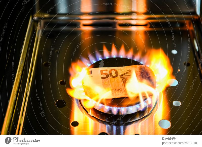 der Gaspreis ist heiß - Geld geht über einem Gasherd in Flammen auf gaspreise teuer verbrennen Energie Rechnung Heizen heizung Konzept euro Geldschein symbol