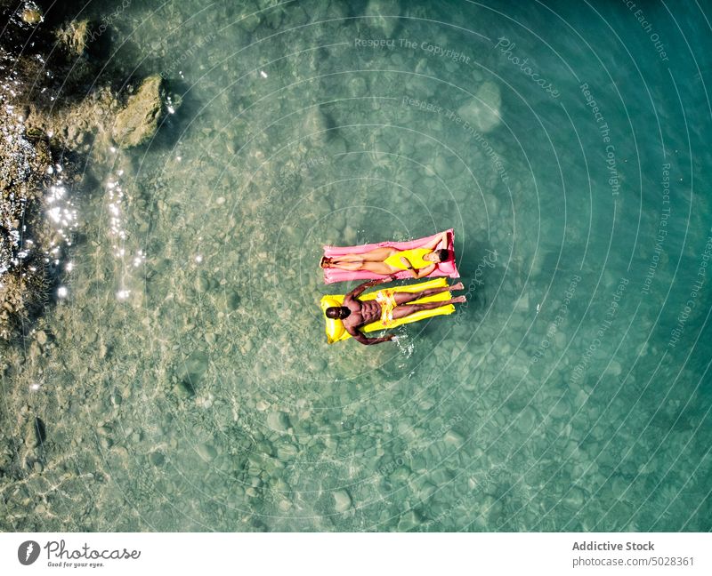 Vielfältiges Paar chillt auf Schwimmern See Sommer Urlaub Sauberkeit Wasser Zusammensein Wochenende reisen Freundin Feiertag vielfältig rassenübergreifend