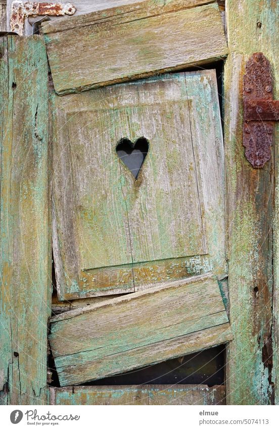 alter, kaputter Fensterladen aus Holz mit einem ausgesparten Herz Herzchen wohnen marode aussparen zerfallen Wandel & Veränderung Vergänglichkeit Verfall