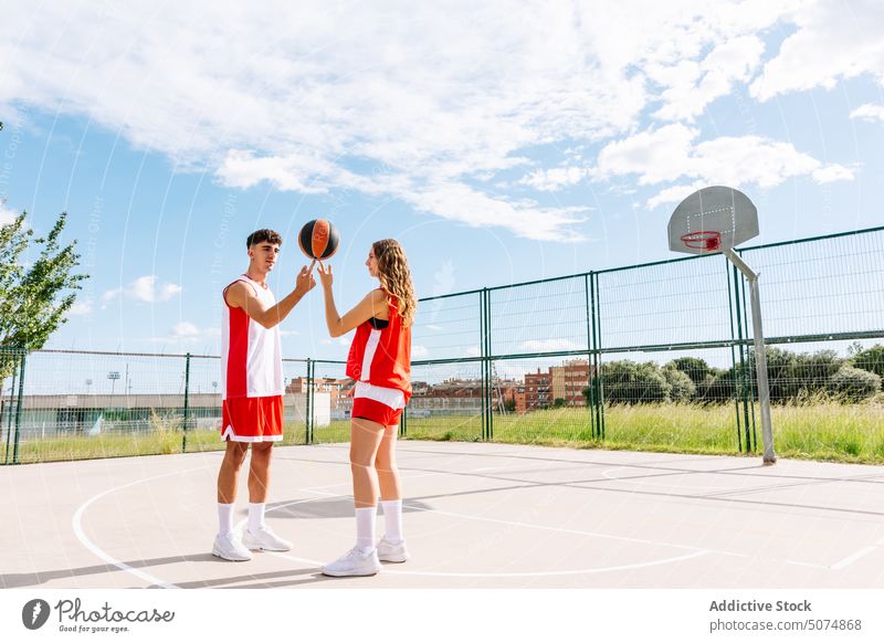 Junger Mann und Frau halten Basketball auf einem Sportplatz im Park Sportler Sportlerin Halt eintauchen Ball konkurrieren werfen Eins gegen Eins punkten Korb