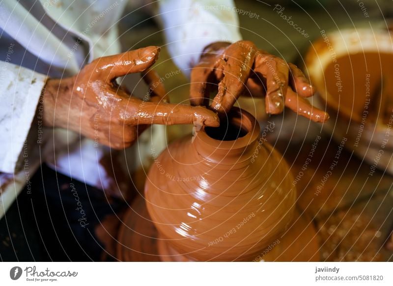 Handwerker, der ein Stück Keramik auf einer arabischen Töpferscheibe formt. Kunsthandwerker Ton Töpferwaren Formen Rad Handwerkskunst Topf Werkstatt