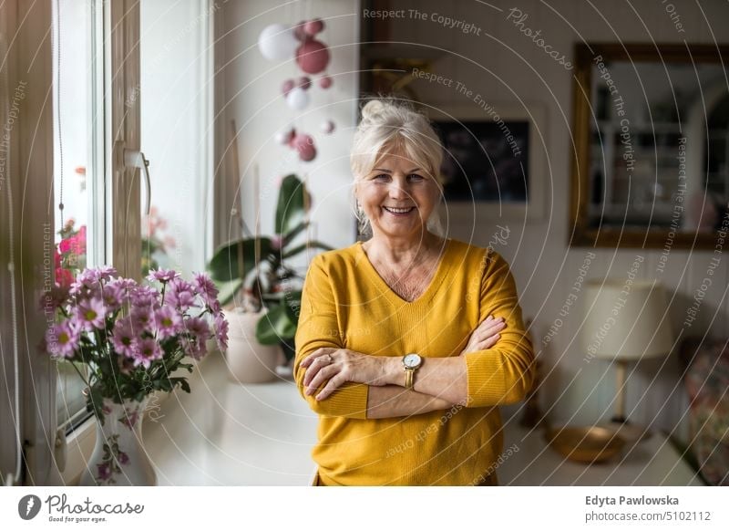 Porträt einer älteren Frau in ihrer Wohnung Lächeln Glück genießend positiv Freude Menschen Senior reif heimwärts Haus alt Alterung häusliches Leben Großmutter
