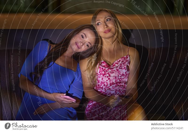 Mutter und Tochter auf einer Bank bei Nacht Frauen fettarm Zusammensein Wochenende dunkel Nachtleben Lebensmitte reif jung Smartphone Stil Kleid Abend