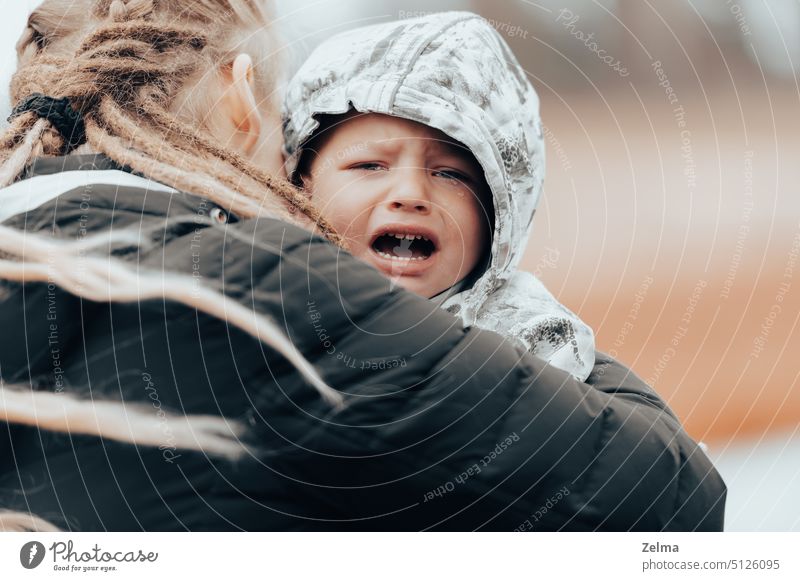 Mutter hält weinendes Baby, trauriger kleiner Junge wird von seiner Mutter umarmt Mama Beteiligung Weinen wenig Sohn Kind umarmend emotional Stress