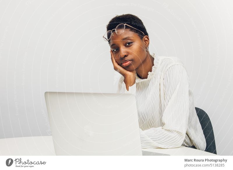 Schwarze Frau benutzt einen Laptop im Büro Suchtmittel Anwendungsjob schön im Internet surfen Laptop durchsuchen Karriere-Kurs lässig bequem Mitteilung