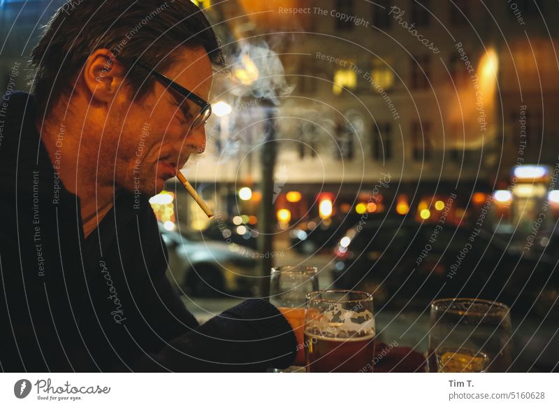 Mann mit Zigarette und Bier im Fenster eines Cafe Berlin Rauchen Nacht Prenzlauer Berg Winter Stadt Hauptstadt Stadtzentrum Innenaufnahme Farbfoto