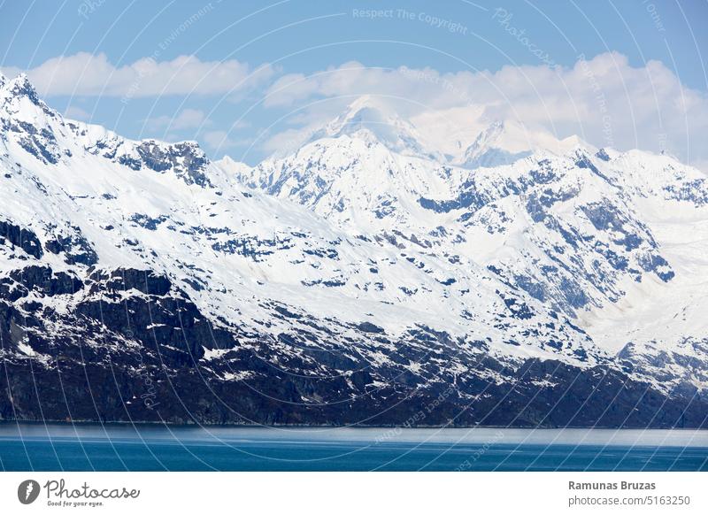Glacier Bay Snowy Mountain Range Ansicht malerisch Natur Bucht Wasser blau Ufer Küste Küstenlinie Felsen steil Berge u. Gebirge Schnee Frühling Saison Gipfel