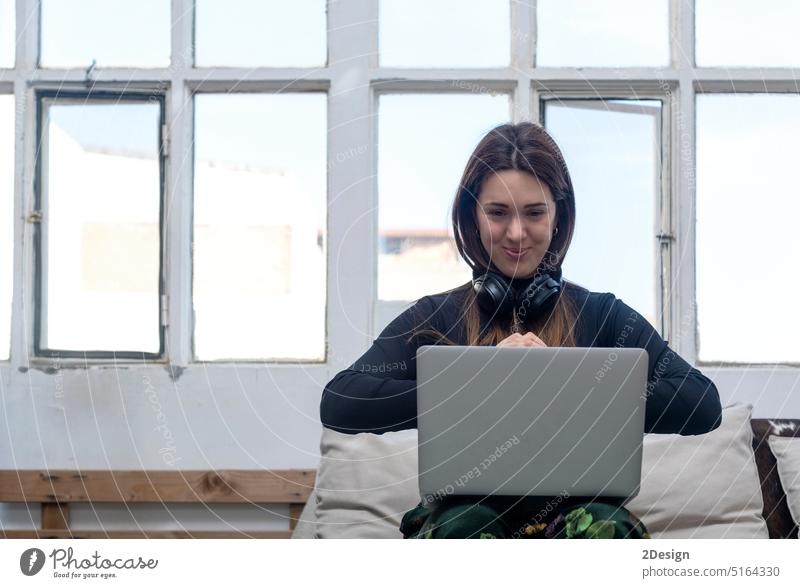Schöne Geschäftsfrau sitzt mit einem Laptop in der Hand zu Hause im Innenbereich Person Computer Frau heimwärts jung Sitzen Beteiligung Lifestyle schön online