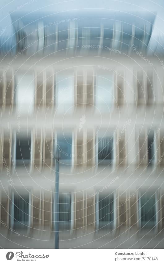 Hausfassade mit gleichmäßig angeordneten Fenstern und Straßenlaterne in ICM Fensterfront Bewegungsunschärfe Großstadt wohnen unscharf abstrakte Fotografie