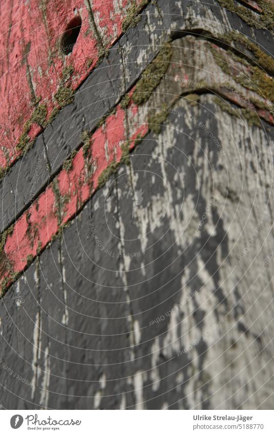Holz verwittert an einem rot schwarzen Strandpfahl/Paal Pfahl Holzpfahl Holzpaal gestrichenes Holz Farbe blättert ab abblättern verwittern Detailaufnahme alt