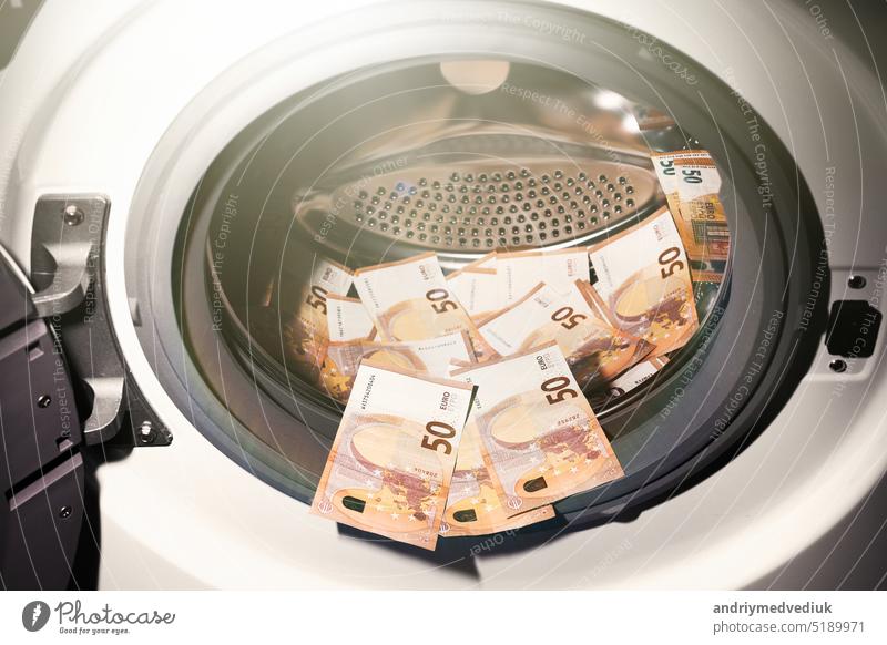 50-Euro-Banknoten in der Waschmaschine. Geldwäschesymbol. Steuerhinterziehung. Illegale Finanztransaktionen. Euro-Währung Maschine Waschen Business