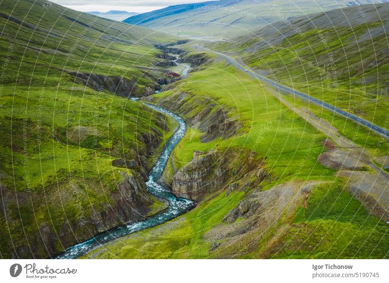 Luftaufnahme einer abgelegenen Bergstraße und eines Flusses im nördlichen Tal in Island, Sommerzeit Antenne Ansicht Straße grün Landschaft Berge u. Gebirge