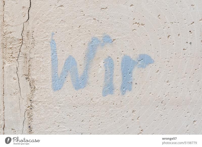 Wir | mit hellblauer Farbe an eine Betonwand gesprüht Grafitto farbe message Botschaft szene urban Schrift hellblaue Farbe Stadt Freundschaft Liebe Vertrauen