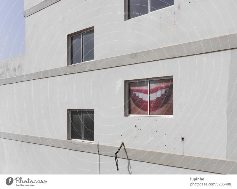 Rollo mit Abbildung eines offenen Damenmundes Hauswand Fenster Mund Zähne