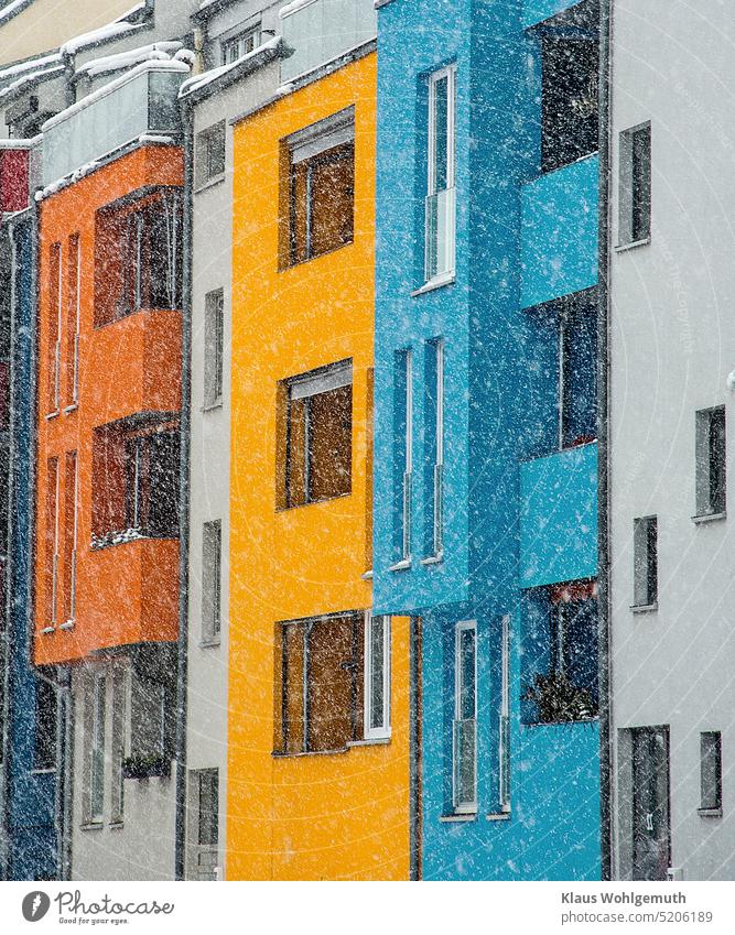 Farbenfrohe Fassade von Wohnhäusern im Schneetreiben. Architektur Wohnhaus wohngebäude Fenster Haus Stadt Gebäude wohnen Außenaufnahme Mehrfamilienhaus