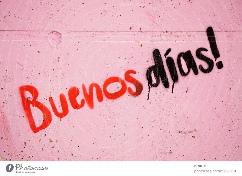 Buenos dias! steht in roten und schwarzen Buchstaben an einer altrosa Betonwand buenos dias Guten Tag Guten Morgen spanisch Begrüßung Begrüßungsworte
