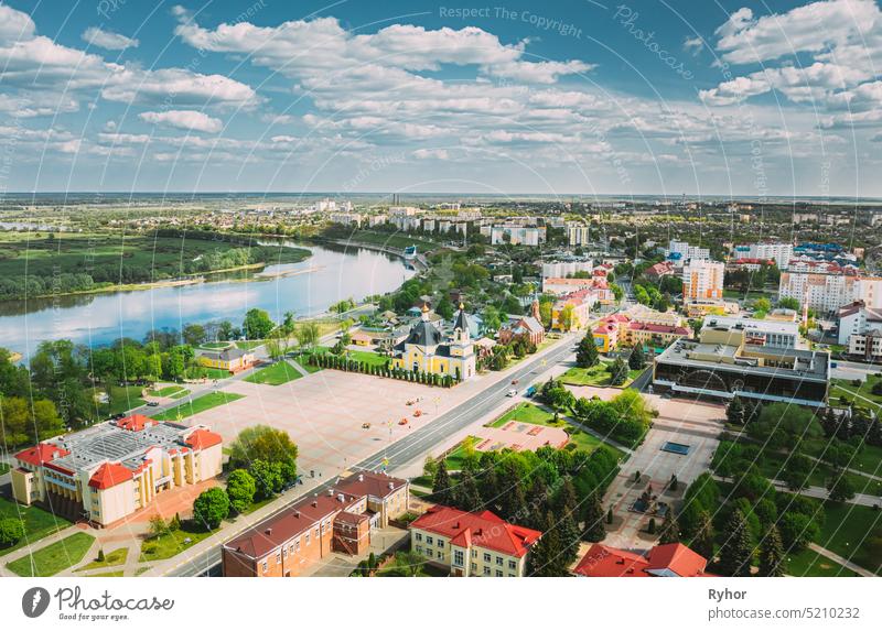 Rechytsa, Weißrussland. Aerial View of Residential Houses and Famous Landmarks Of Town: Holy Assumption Cathedral and Holy Trinity Church In Sunny Summer Day.
