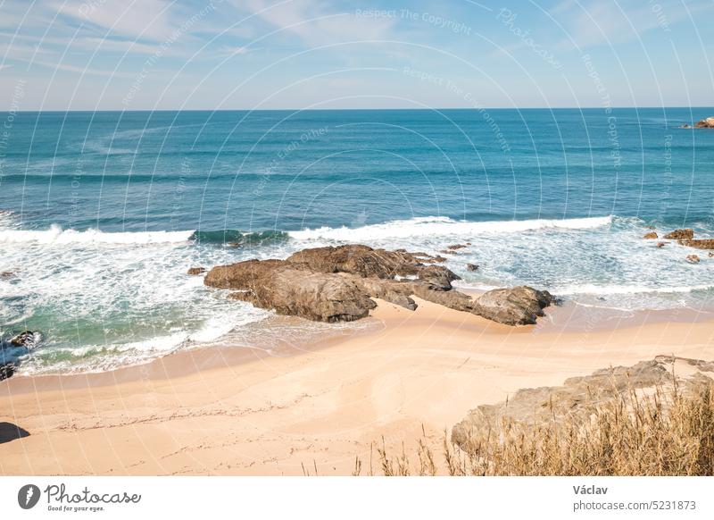 Felsen umgeben den Sandstrand an der Atlantikküste bei Vila Nova de Milfontes, Odemira, Portugal. Auf den Spuren der Rota Vicentina. Fischerpfad friedlich Reise