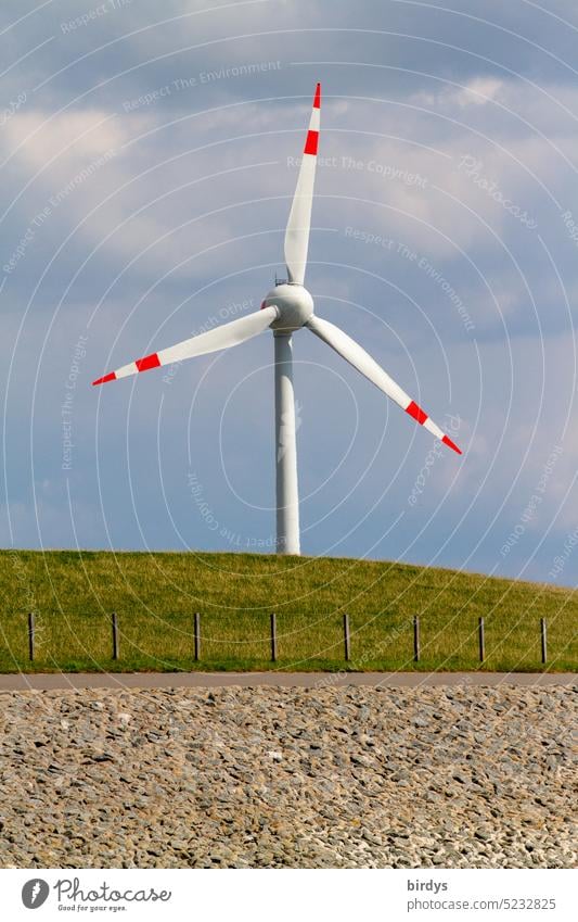 Windkraftanlage hinter einem Deich Windrad Erneuerbare Energie umweltfreundlich Windenergie Küste Ökostrom Klimawandel Elektrizität grüne Energie