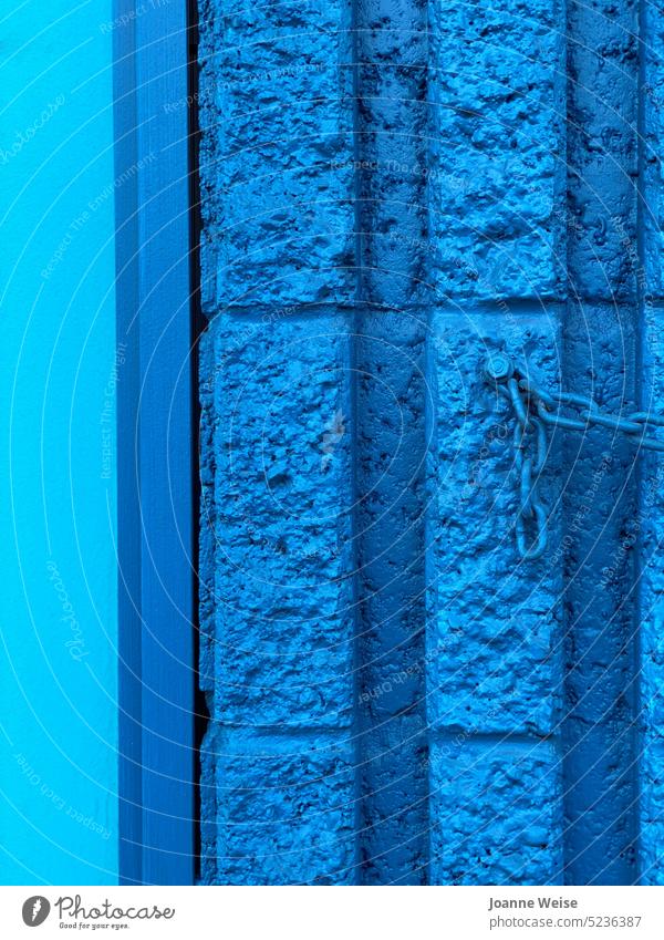 Blaue Wand mit blauer Kette blaue Wand anketten Kettenglied Blöcke Außenaufnahme Farbfoto Nahaufnahme stark Anschluss Eisenkette Monochrom Hellblau