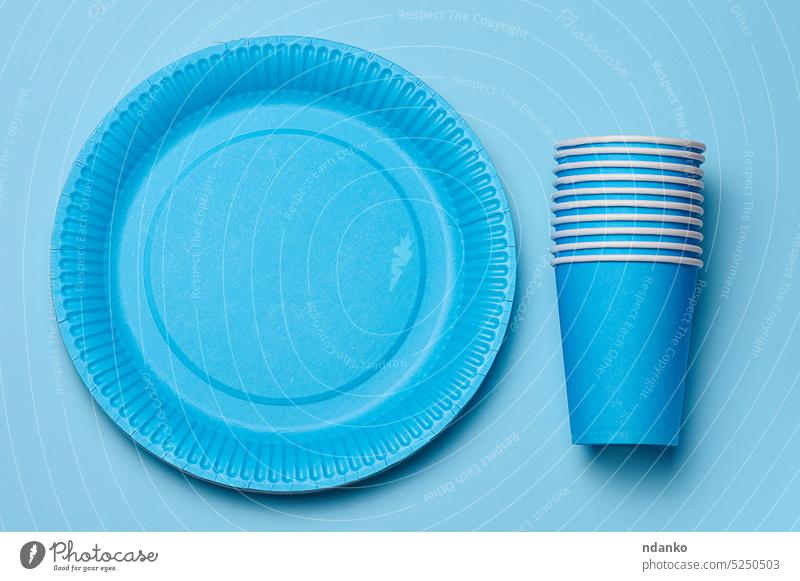 Runde blaue Einweg-Papierteller und -Becher für ein Picknick, wiederverwertbarer Abfall, Ansicht von oben. Einwegartikel Teller Tasse Recycling Umwelt