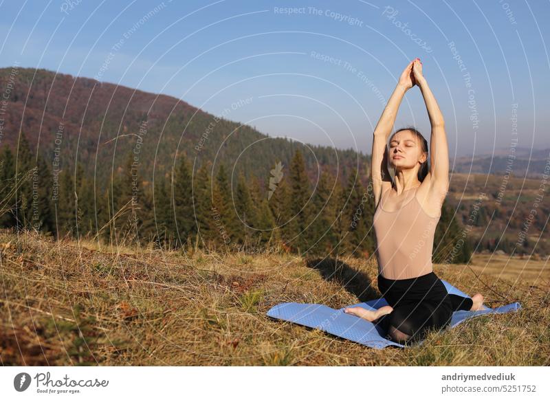 Junges Mädchen macht Yoga Fitness-Übung im Freien in schönen Bergen Landschaft. Morgen Sonnenaufgang, Namaste Lotus Pose. Meditation und Entspannung. Gesunder Lebensstil.