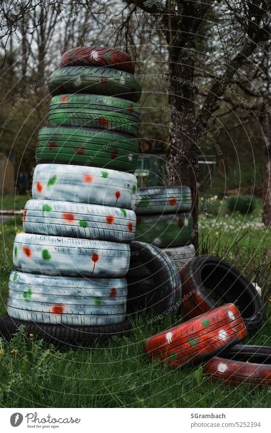 Der etwas andere Frühling, Reifenstapel angemalt, Frühlingsfarben Autoreifen Recycling Reifenprofil Außenaufnahme Umweltverschmutzung Gummi Müll entsorgen