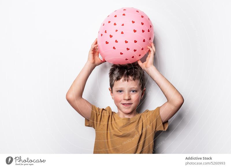 Junge spielt mit rosa Luftballon Herz spielen Liebe Valentinstag (Heiliger Valentinstag) aufblasbar Feiertag Symbol niedlich Kind Form romantisch spielerisch